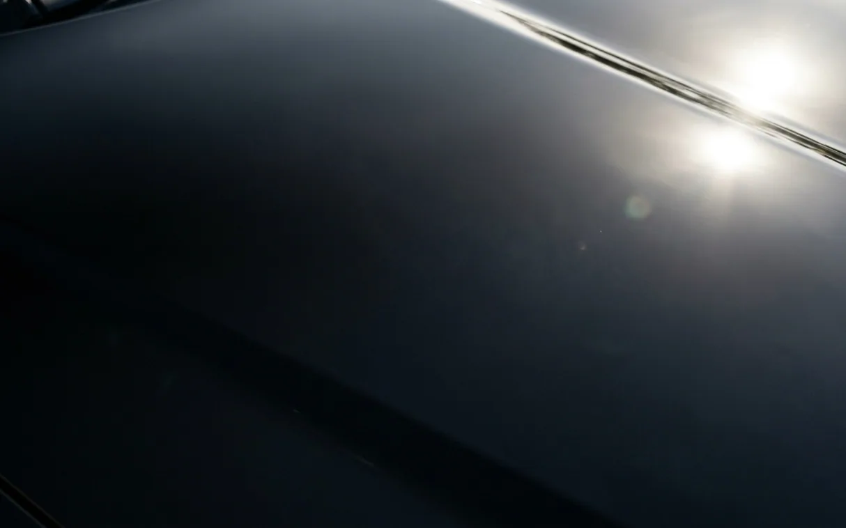 The same bonnet after correction, deep and clear under the lamp
