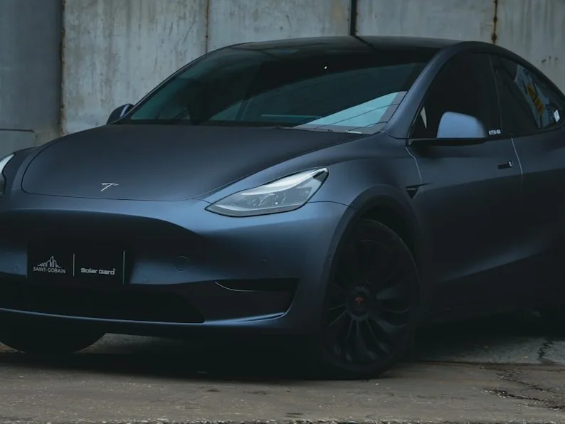 Tesla Model Y — the named car, dark and glossy